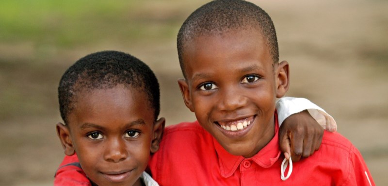 Two boys hugging each other SOS Children's Village Zanzibar, Tanzania. Photo: Katja Snozzi