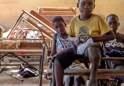 Tre gutter på skadet skole etter syklon i Mosambik. Foto: SOS-barnebyer