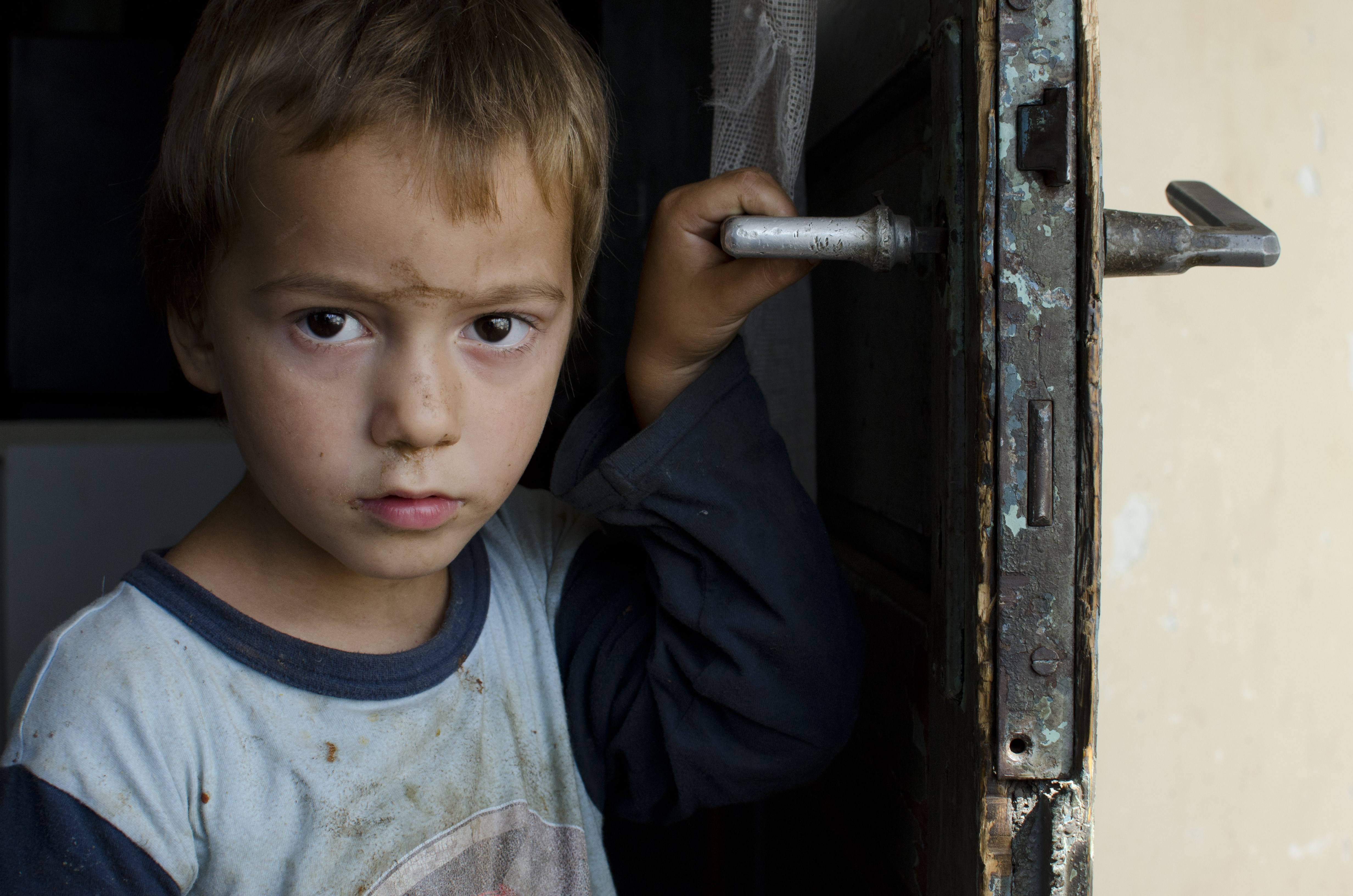 Alvorlig gutt holder i et dørhåndtak. Illustrasjonsfoto: Katerina Ilievska
